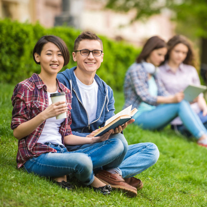 Students sitting outside on campus.